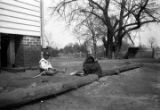 Children in the dirt yard of a wooden house, probably in Furman, Alabama.