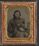 [Thomas Isaiah Booker in Confederate uniform with Colt navy revolver, book, tin drum canteen, and sign reading Jeff Davis and the South!]