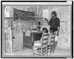 Negro mother teaching children numbers and alphabet in home of sharecropper. Transylvania, Louisiana