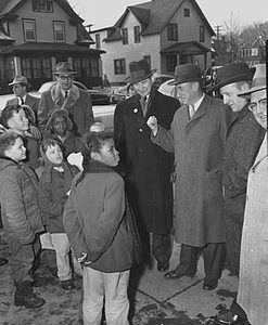 Governor Orville Freeman and Adlai Stevenson talking to a group of children.