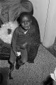 Gerald Dabney sitting on a sofa in the living room of his grandparents' home in the Madison Park community of Montgomery, Alabama.