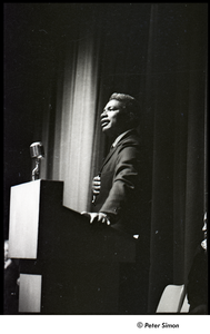 Martin Luther King Jr. rally at the Fieldston School: Ossie Davis speaking, Ruby Dee (partially obscured) seated on right