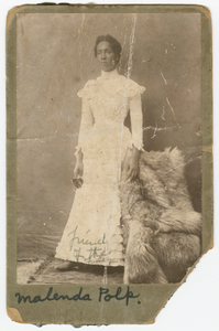 Photograph of Malenda Polk wearing a white, high collar dress.