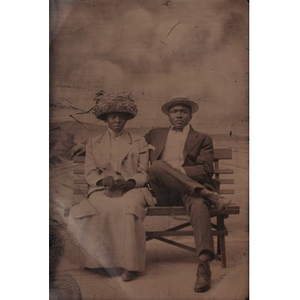 An African American couple sitting on a bench