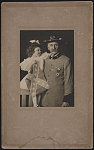 [Civil War veteran Thomas Benjamin Amiss in U.C.V. uniform with medals holding young girl with Confederate flag]