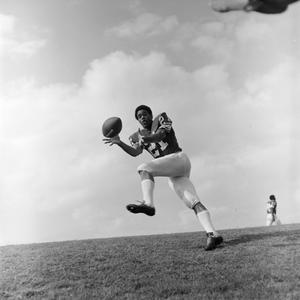 Football player reaching for the ball, 3