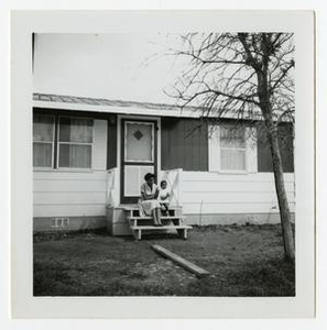 Woman and Child Outside a House