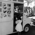 Girl buying a popsicle from an ice cream truck during a voting rights march in Mobile, Alabama.