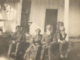 Four African Americans sitting on a porch in Fort Mitchell, Alabama.