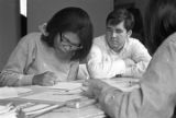 Students from Bessemer High School at a table with tutors in the basement of St. Paul's Lutheran Church in Birmingham, Alabama.