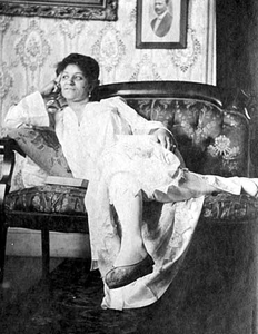 African-American woman seated on a sofa