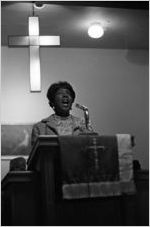 Woman singing before an audience at Hall Street Baptist Church in Montgomery, Alabama.