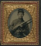 [Unidentified young soldier in Union uniform holding musket with Prescott revolver in belt]