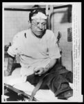 [James Peck, seated on a hospital gurney in Birmingham, Alabama,  following attack on a "Freedom Riders" bus]