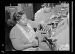 Production. Aircraft engines. Negro women with no previous industrial experience are reconditioning used spark plugs in a large Midwest airplane plant. Despite their lack of technical knowlege, these women have become expert operators of the small testing machines. Melrose Park, Buick plant