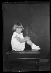 Portrait of girl sitting on desk