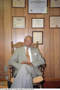 Louis A. Bedford, Jr. sitting in front of his law credentials #2