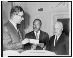 [Rev. Martin Luther King receiving check for Alabama voter registration drive from Albert Shanker, president of the United Federation of Teachers, and Morris Iushewitz]