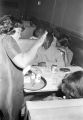 Waitress serving people seated at a table at the Laicos Club in Montgomery, Alabama.