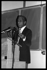 James Baldwin lecturing at UMass Amherst Baldwin standing at a podium with microphones