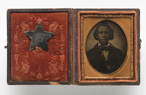 Tintype portrait of Creed Miller with star-shaped military identification pin