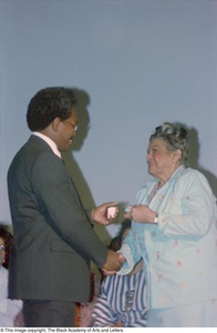 Photograph of a man and woman shaking hands