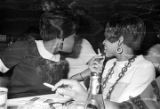 Barbara Howard Flowers and another woman, seated at a table at the Laicos Club in Montgomery, Alabama.