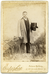 Portrait of unidentified man holding top hat and cane