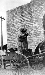 Deliveryman Standing on His Wagon