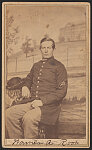 [Hospital Steward Warner A. Root of Co. G, 2nd Massachusetts Infantry Regiment and U.S. Army Hospital Stewards in uniform in front of painted backdrop showing large building in the distance]