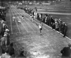 Ralph Metcalfe crossing finish line at MU-Wisconsin dual, 1934?