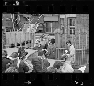Press waiting for Boston University President Dr. Arland Christ-Janer as he exits gates