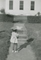 Caroline Elain Cooke with an umbrella in front of a house in Camden, Alabama.