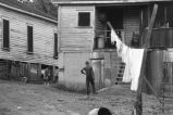 Children behind houses.