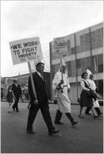 Klansmen and other marchers carrying signs in a parade during a Ku Klux Klan rally in Montgomery, Alabama.