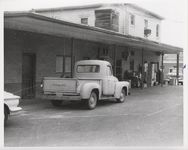 Mississippi State Sovereignty Commission photograph of three vehicles parked outside the rear entrance to Stanley's Cafe and the Trailways bus depot, Winona, Mississippi, 1961 November 1