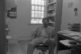 John Blassingame: New York. John Blassingame seated in office, Fredrick Douglas portrait on the wall (BLJP 1-79 #101)