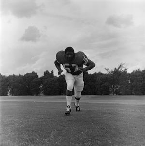 Football player running on the field, 71