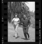 Muhammad Ali jogging with California's Secretary of State, March Fong Eu in Los Angeles, Calif., 1980