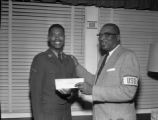 Private James W. Luck receives an award at the Taylor Street U.S.O.