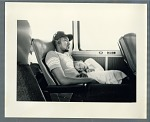 Man and child sleeping on bus