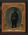 [Unidentified soldier in Union uniform and infantry Hardee hat with musket, revolver, and Bowie knife with sheath]