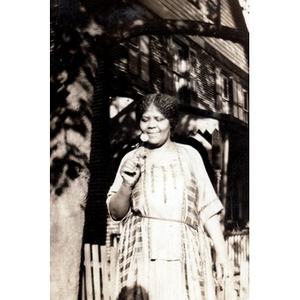 An African American women holding a flower