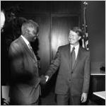 Governor Jimmy Carter shaking hands with Dr. Benjamin E. Mays who recieved the Outstanding Older Georgian Award, Morehouse College, Atlanta, Georgia, August 6, 1971.