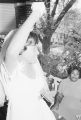 Josephine Bradford waving from the porch of her parents' home in Montgomery, Alabama, during the reception following her wedding to Walter Bradley.