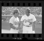 Dodgers Maury Wills and Frank Robinson talking during game in 1972