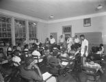 Andy Farnell, salesman for the Coca-Cola Bottling Company in Montgomery, Alabama, giving promotional pads and pencils to African American students.