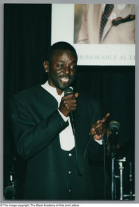 Photograph of an unidentified man holding a microphone