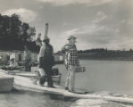 Swann's Dock on Douglas Lake; John B. Ruble of Newport, Tenn. carrying fish; Jasper Humphreys, a dock worker, behind him. Several unidentified men on the dock and in boats in the background.