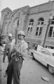 Police officer standing guard outside 16th Street Baptist Church in Birmingham, Alabama, after the building was bombed.